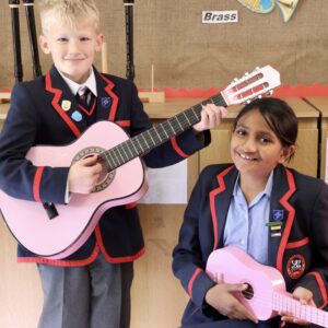 children holding guitars