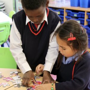 children completing a puzzle