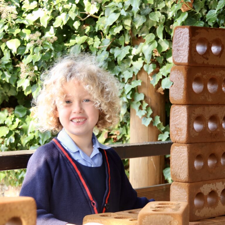 girl standing behind a wall